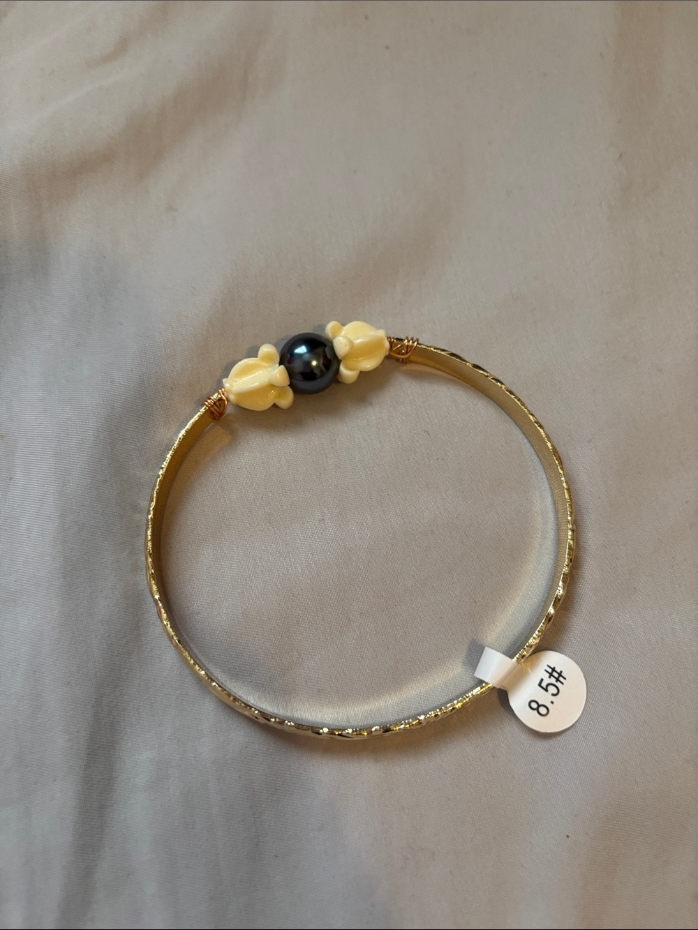 Gold plated Hawaiian Bangle Bracelet with Black Pearl and crown flower charm